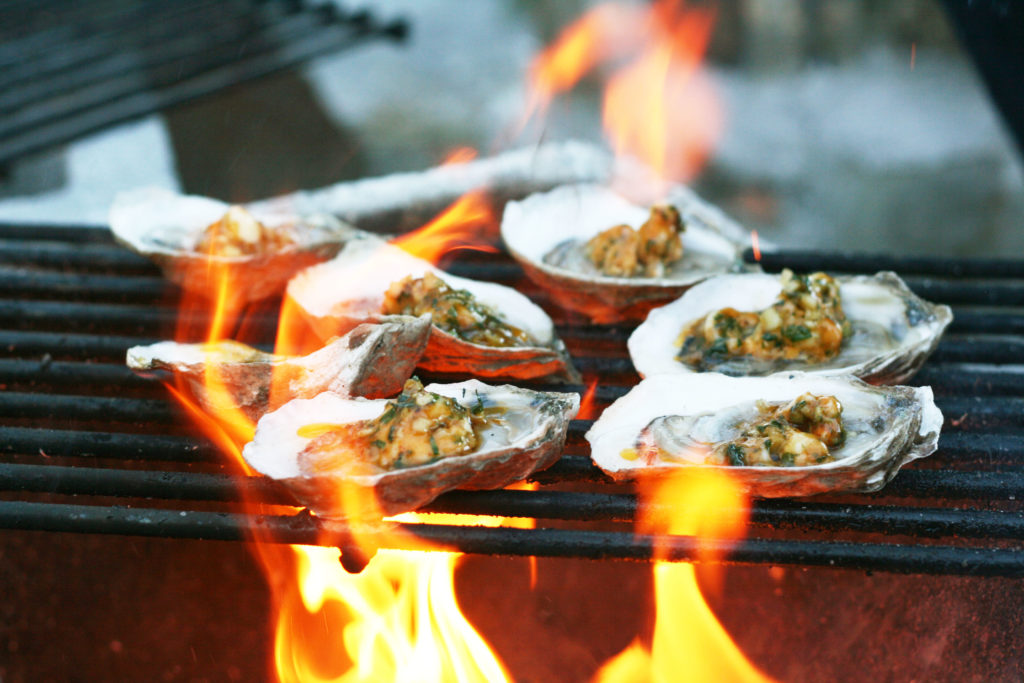 Oysters topped with garlic butter and grilled